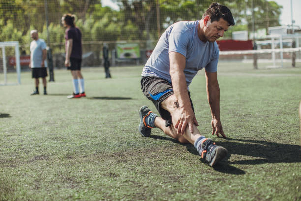 istock Male soccer players stretching 1199046677
