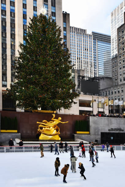 New York experience New York, NY, USA - December 5, 2019. The famous Rockefeller Center with Ice Skating , Christmas Tree and Prometheus Statue at Rockefeller Center. rockefeller ice rink stock pictures, royalty-free photos & images