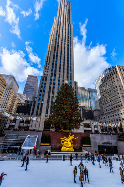 New York experience New York, NY, USA - December 5, 2019. The famous Rockefeller Center with Ice Skating , Christmas Tree and Prometheus Statue at Rockefeller Center. rockefeller ice rink stock pictures, royalty-free photos & images