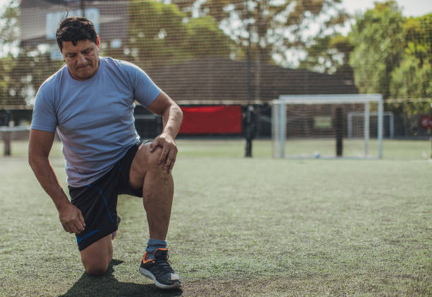 istock Male soccer players stretching 1199047217