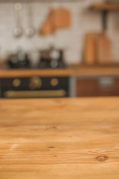 Christmas kitchen decor and copy space. Rustic kitchen in defocus. Wooden table in focus.