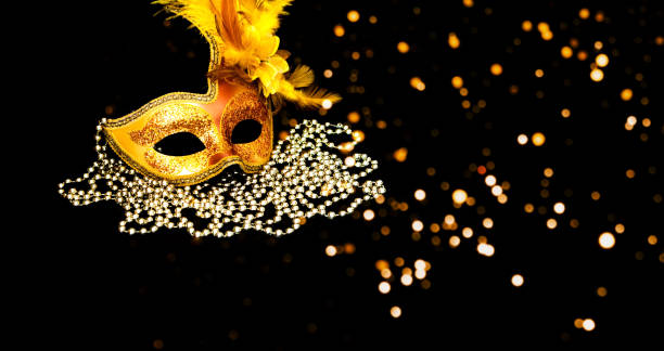 istock Golden Carnival mask on black background with silver beads. Mardi Gras concept. Copy space 1199048429
