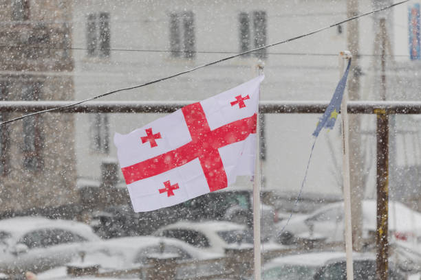 istock Georgian flag waving in the wind in a snowfall 1199048618
