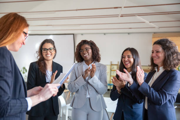istock Cheerful coworkers applauding after presentation 1199049755