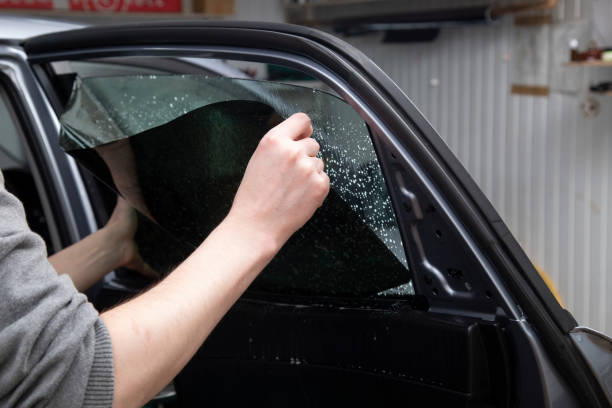 istock Installation of window film on car Windows. 1199049780