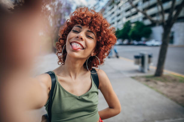 istock Young woman shooting selfie 1199051391