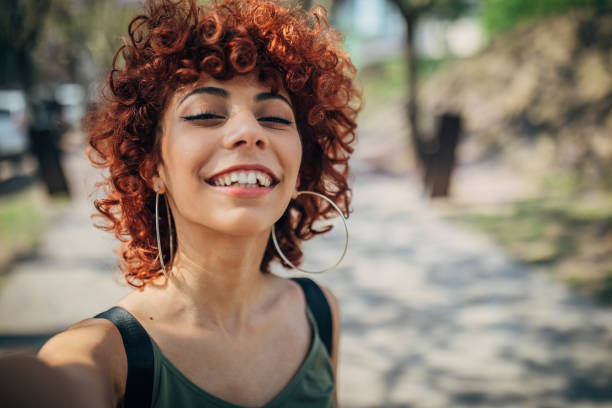 istock Young woman shooting selfie 1199051434
