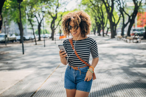 istock Woman using phone outdoors 1199051520