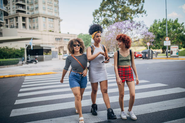 istock Three young women walking outdoors 1199052554