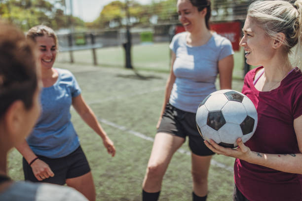 istock Women standing on a soccer playing field 1199053505