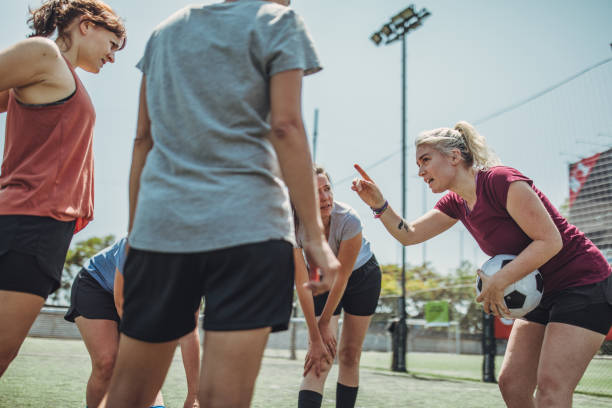istock Women standing on a soccer playing field 1199053611