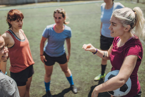 istock Women standing on a soccer playing field 1199053656