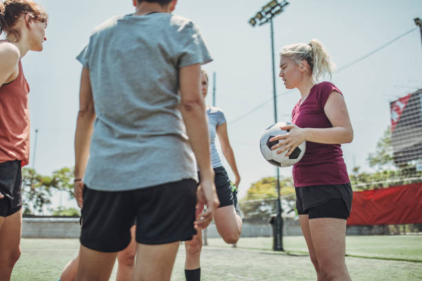 istock Women standing on a soccer playing field 1199054239
