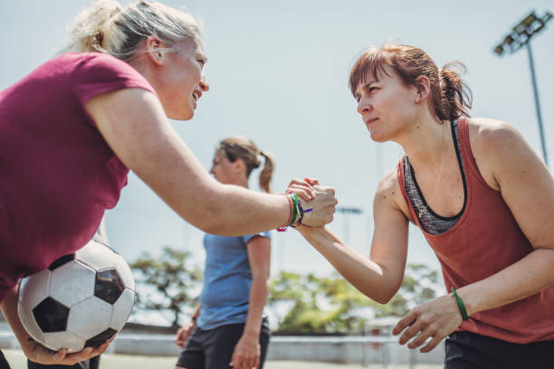 istock Women handshake on a soccer playing field 1199055036