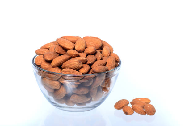 istock Almonds in a bowl isolated on a white background 1199056896