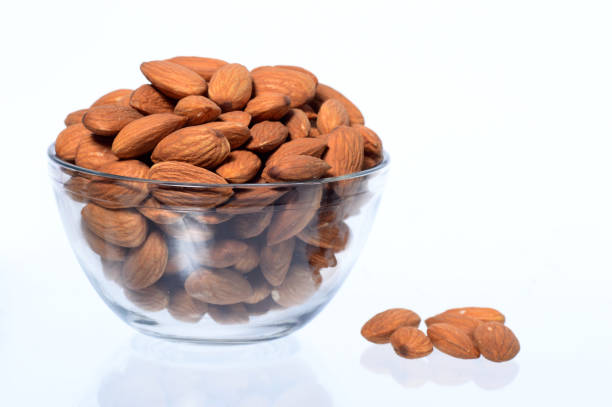 istock Almonds in a bowl isolated on a white background 1199057280
