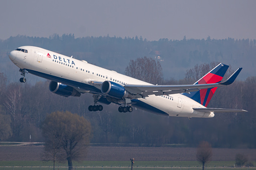 Munich, Germany - April 2, 2019: Delta Air Lines Boeing 767 airplane at Munich airport (MUC) in Germany. Boeing is an aircraft manufacturer based in Seattle, Washington.