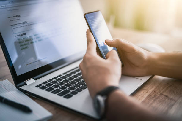 istock Man works at home and uses a smart phone and notebook computer. 1199059168