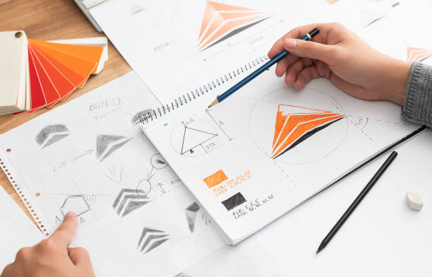 istock Graphic designer drawing sketches logo design. 1199059362