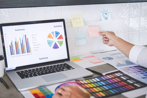 istock Young creative graphic designer working on project architectural drawing and color swatches, selection coloring on graphic chart with work tools and equipment 1199059577