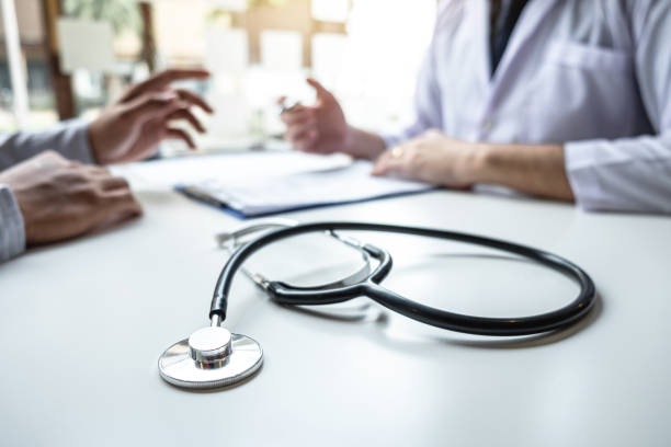 istock Doctor consulting with patient and checking sickness condition while presenting results diagnosis symptom examining about the problem of illness and recommend treatment method, Healthcare and medical 1199059632