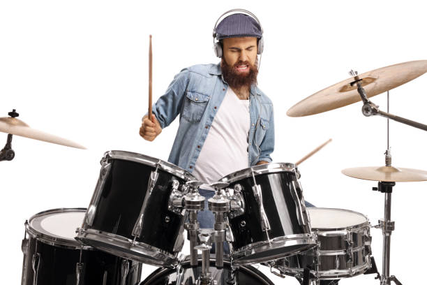 istock Bearded man with headphones playing a drum set 1199060304
