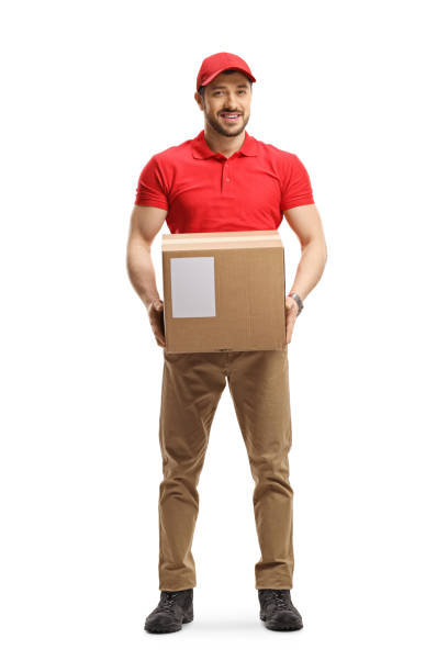 istock Delivery man holding a cardboard box 1199060665