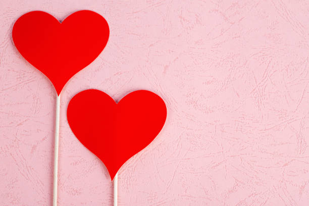 Red hearts on pink background with copy space
