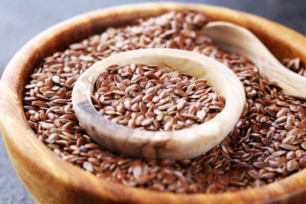 istock Uncooked linseed in wooden spoon, rustic style. Healthy linseed 1199061683