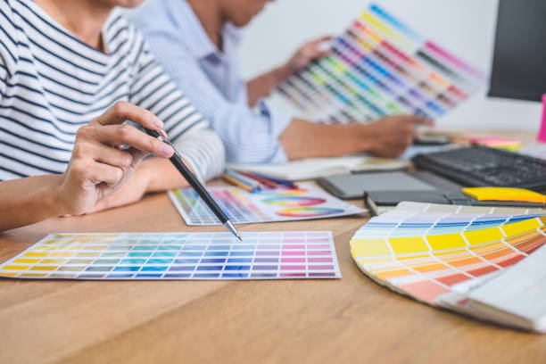 istock Young creative team having a meeting in creative office, Architectural drawing with work tools and accessories, Color swatch samples chart for selection coloring 1199062559
