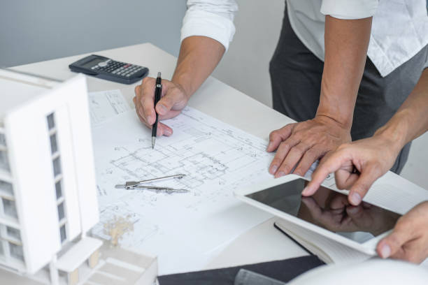 istock Architecture Engineer Teamwork Meeting, Drawing and working for architectural project and engineering tools on workplace, concept of worksite on technical drawing structure and construction 1199062632
