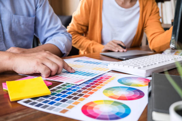 istock Two colleagues creative graphic designer working on color selection and drawing on graphics tablet at workplace 1199062664