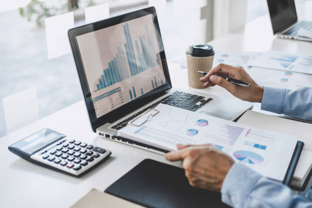 istock Professional at work, business woman working and analyzing on laptop with calculate statistics of financial document data graph for new project of business strategy and market growth at workplace 1199062666