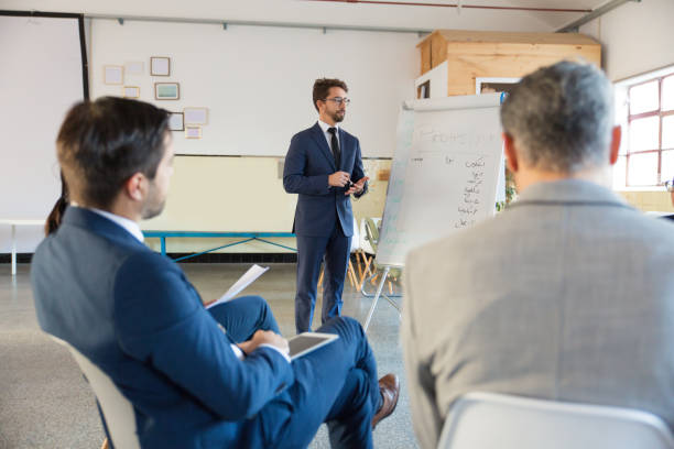 istock Focused speaker standing near whiteboard 1199062720