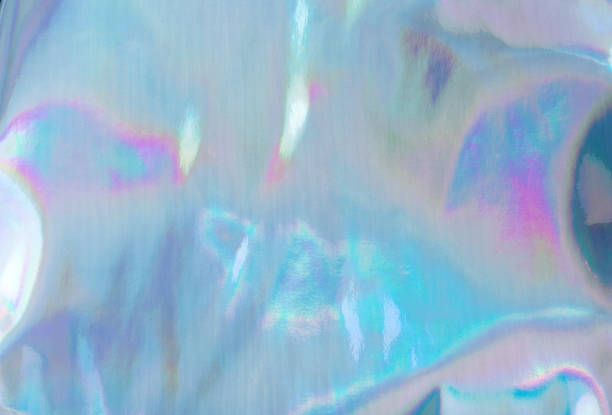 istock Holographic Foil Texture. Abstract soft pastel iridescent background. Rainbow color sunlight spots and gradient 1199065346