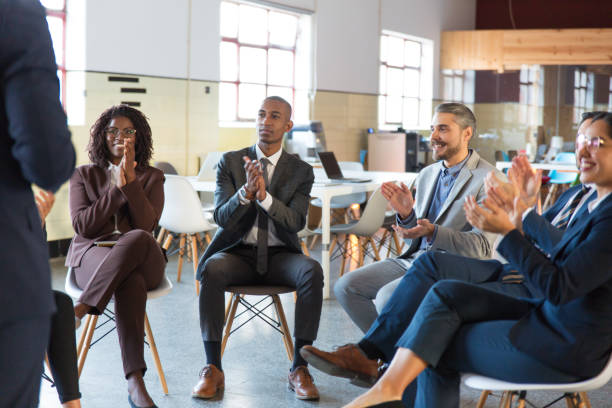 istock Colleagues applauding after successful presentation 1199066738