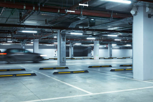 Horizontal image of underground parking lot with car stock photo