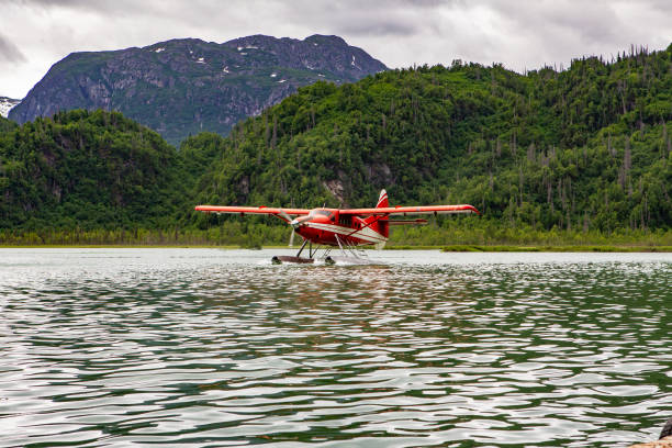 istock Red and white float plane taxiing on a lake 1199068121