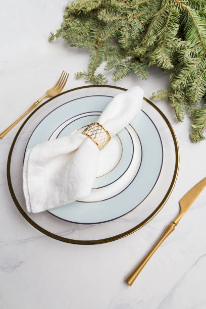 istock Empty plate with fork and knife and white napkin with gold ring. 1199069174