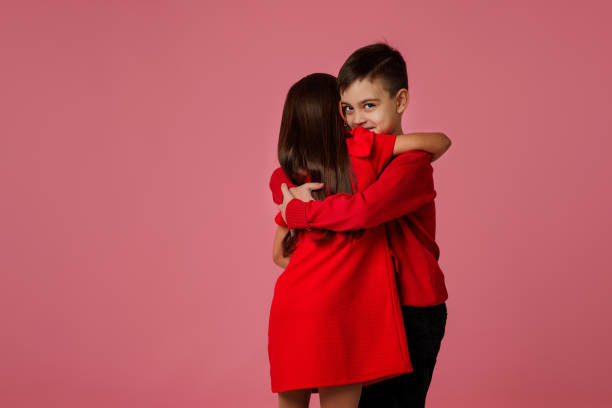 istock child girl and boy with gift box hugging 1199069275