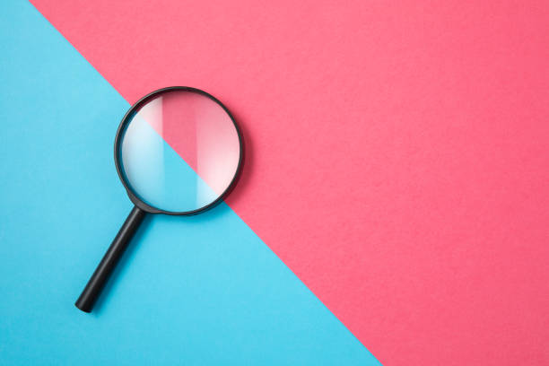 istock Magnifying Glass on Two Tone Color Background 1199070559