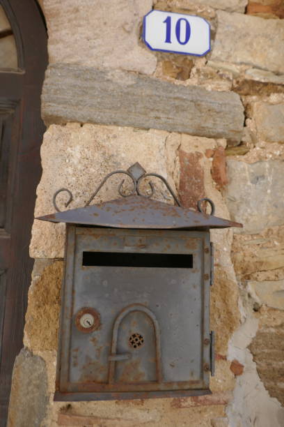 Antique metal letterbox hangs on the wall.