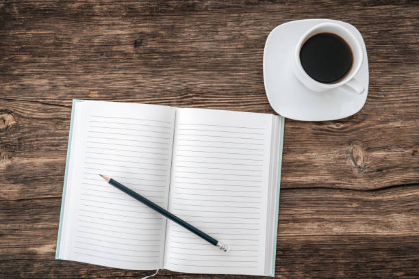 istock Pencil and an open notebook on white table. Bird eye view, mock-up concept. 1199071482