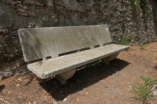 An old weathered concrete bench.