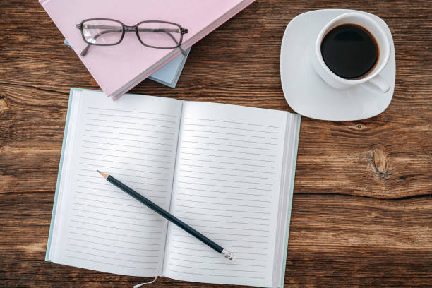 istock Pencil and an open notebook on white table. Bird eye view, mock-up concept. 1199072122