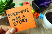 Slogan everyone has a story handwritten on sticky note