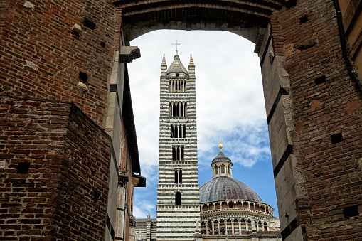 View of the Dome & Bell Tower of Siena Cathedral (Duomo di Siena), landmark Mangia Tower and Basilica of San Domenico, Italy