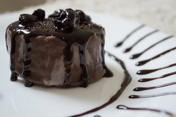 istock Decorated chocolate cake on plate decorated with toping 1199076754