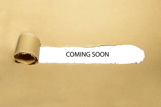 Coming Soon Ripped Paper Concept The phrase Coming Soon appearing behind ripped brown paper. Concept about upcoming promising event approaching in near future. launch event photos stock pictures, royalty-free photos & images