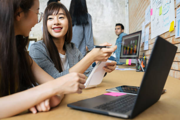 istock Business people are working on laptop at creative office workplace. Asian creative team meeting and working design planning ideas concept 1199077866